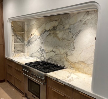 full height granite backsplash in modern luxury kitchen