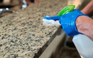 cleaning granite countertop with microfiber cloth and gentle cleaner  