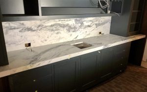 cleaning marble countertops in a bright luxury kitchen