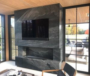 custom granite fireplace surround in luxury living room