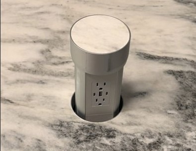 Pop-up outlet raised from a countertop providing hidden power access in a modern Columbus, Ohio kitchen