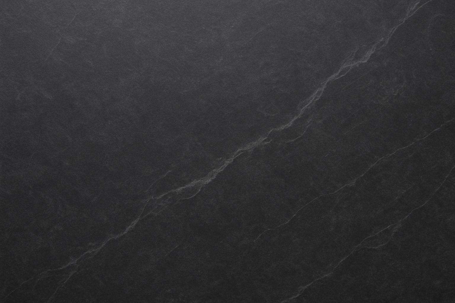 Dark charcoal soapstone close-up showing natural matte texture